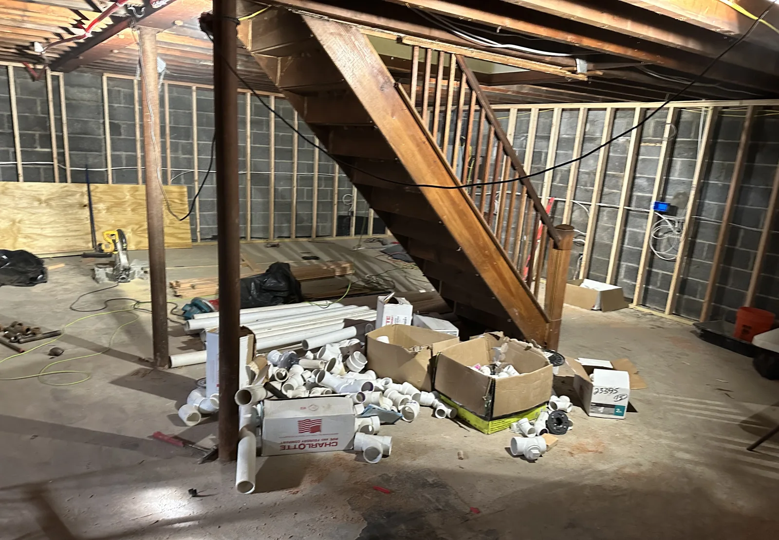 Basement during framing with open studs over a bare concrete floor