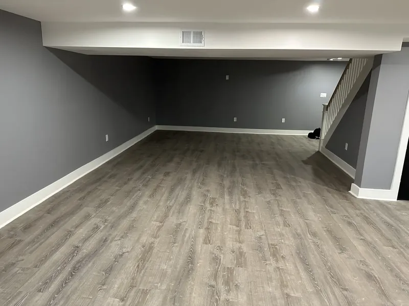 Hackensack, NJ basement finishing: finished basement with gray walls, white trim and recessed lighting