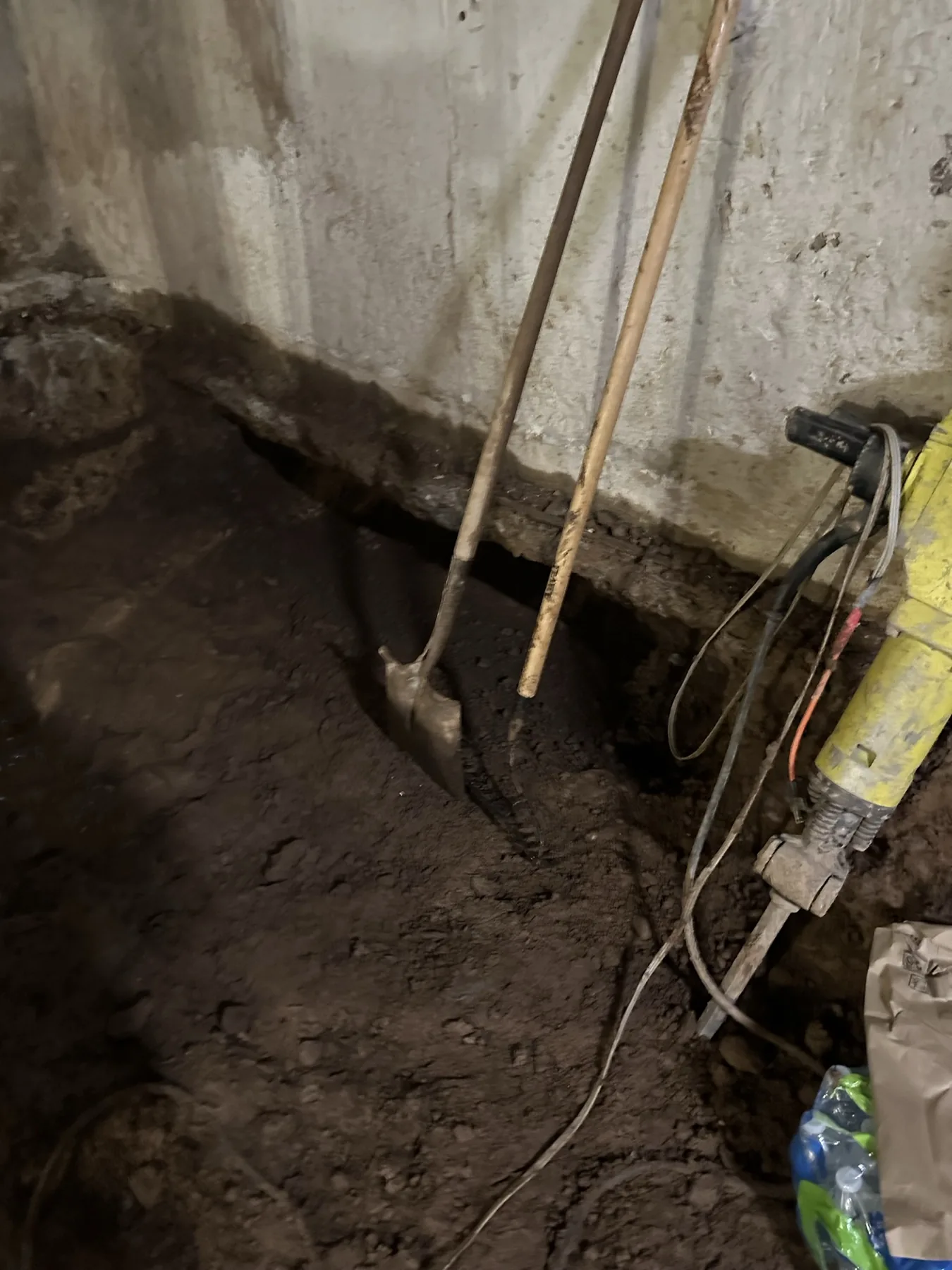 Excavation along an existing footing for underpinning